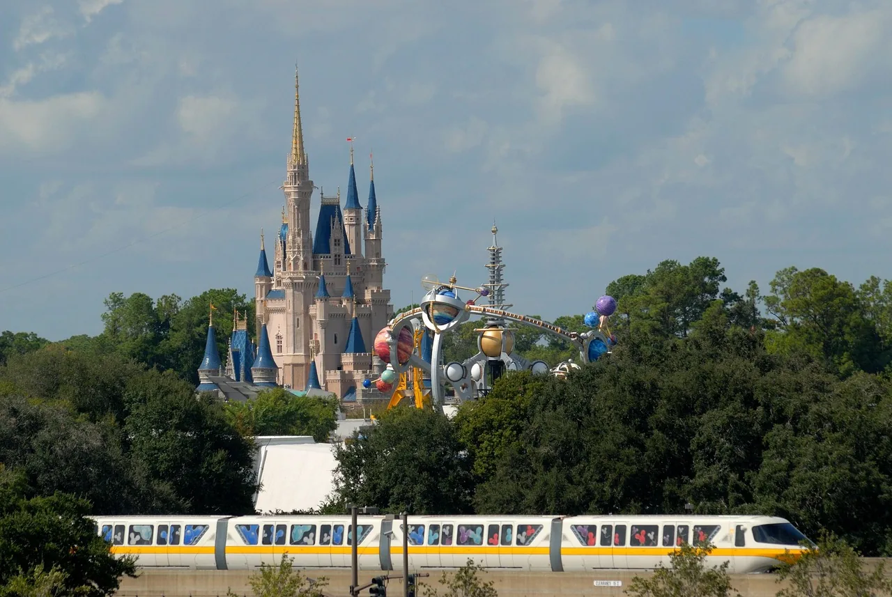 Cinderella Castle rising above the trees at Walt Disney World, with the monorail passing below